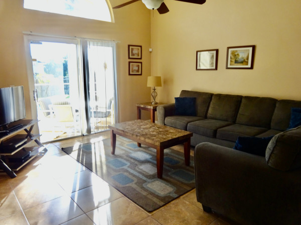 A separate bright and airy area, adjacent to the dining area, with two sofas.