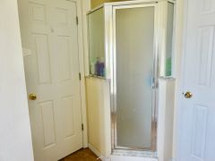 Master en suite bathroom with direct access to the pool and patio, vanity unit, large walk in shower, bath tub and separate toilet.