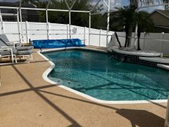 Large south-west facing, fountain pool, with substantial furnished patio area in enclosed screen, surrounded by large grassed gardens.