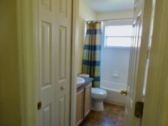 Second En-suite bathroom with shower over bath, vanity and WC.